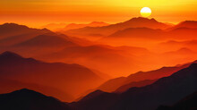 Layers Of Mountains Are Silhouetted Against A Fiery Orange Sunset Creating A Dramatic And Breathtaking Landscape.