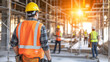 © SnapVault - A construction supervisor walks amidst a metal scaffolding structure inside a building under construction. Teamwork, collaboration, and coordination in an infrastructure project.