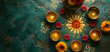 Indian ornamental design of Rangoli pattern in orange color with candles on green background. Ugadi or Gudi Padwa celebration. Indian festival of Diwali. Hindu New Year. Religion and ethnic concept