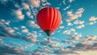 red hot air balloon on bright blue sky 