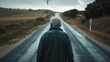 A middleaged man walking down a deserted road his head hung low in despair.