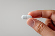 © Ari - Hand holding white pill, healthcare: medicine, antibiotic, supplement