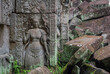 Woman stone carving and moss covered green stone ruin building exterior and bricks at the Banteay Kdei Temple. Angkor Wat historical site park, Siem Reap, Cambodia