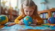 A young, focused girl examines a small globe while surrounded by colorful crayons, engaging in a geography lesson in celebration of Earth Day.