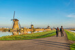 © Noppasinw - Dutch Windmill landscape at Kinderdijk Village Netherlands with love couple walking