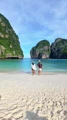 Wall Mural - a couple of men and woman visit Maya Bay Koh Phi Phi Thailand, Turquoise clear water Thailand Koh Pi Pi, Scenic aerial view of Koh Phi Phi Island in Thailand