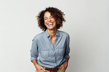 Wall Mural - Portrait of a happy young african american woman laughing against white background