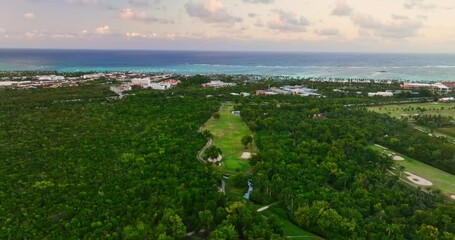 Wall Mural - Aerial view over luxury Caribbean resort with wild jungle, golf course field, tropical beach Punta Cana,Dominican Republic