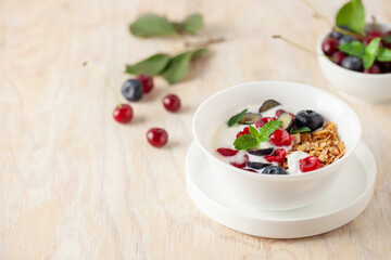 Wall Mural - Cherry and blueberry granola with yogurt. Healthy food, diet breakfast.