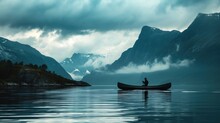 Two People In A Boat On A Body Of Water With Mountains In The Background And Clouds In The Sky Over The Water And In The Water Is A Body Of Water.