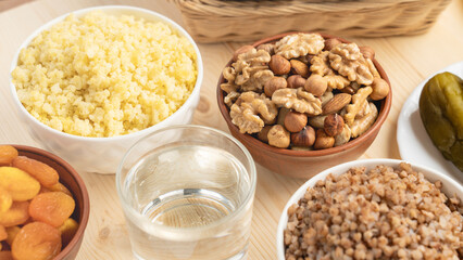 A mixture of nuts and cereal porridge on a wooden table, healthy and wholesome food concept