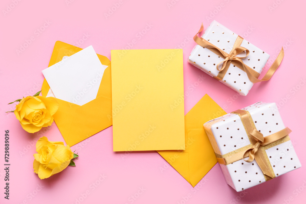 Envelopes with blank cards and gift boxes on pink background. International Women's Day celebration