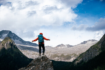 Wall Mural - Woman hiker climbing to mountain top in tibet