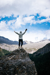 Wall Mural - Woman photographer taking photo on mountain top