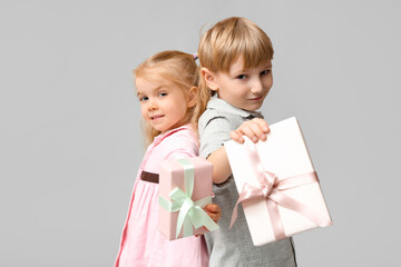 Sticker - Cute little children with gift boxes on grey background. International Women's Day