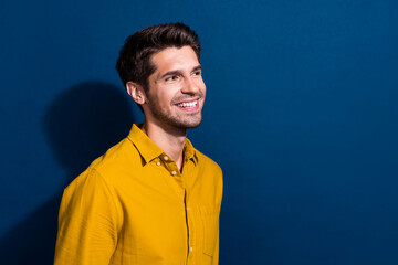 Sticker - Photo portrait of attractive young man look empty space cheerful smile wear trendy yellow clothes isolated on dark blue color background