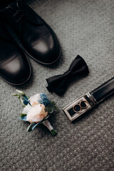 Wall Mural - men's accessories of the groom black leather shoes and a boutonniere