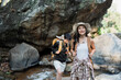 © itchaznong - Happy LGBT Lesbian couple Travelers Hiking with Backpacks in waterfall Trail. LGBT Lesbian Couple Hikers with backpacks walks in mountains in vacation