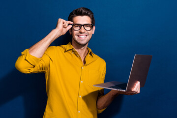 Aufkleber - Photo portrait of attractive young man touch specs hold netbook marketer wear trendy yellow clothes isolated on dark blue color background