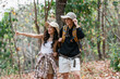 © itchaznong - Happy LGBT Lesbian couple Travelers Hiking with Backpacks in forest Trail. LGBT Lesbian Couple Hikers with backpacks walks in mountains in vacation