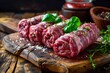 Fresh raw beef roulades on wooden table