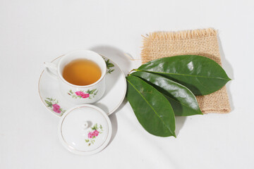 Soursop Leaf Tea or Daun sirsak (Annona Muricata L) is useful as an alternative herbal alternative for anti-bacterial,heart disease and cancer.isolated on white background,herbal medice drink concept.