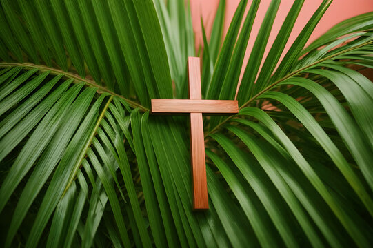 Christian wooden cross with palm tree leaves background 