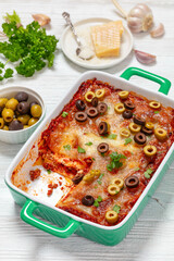 Wall Mural - lasagna with olive rings in green baking dish