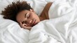 © Andrei - Happy african american woman, 20 years old, sleeping peacefully on white bed with white blanket