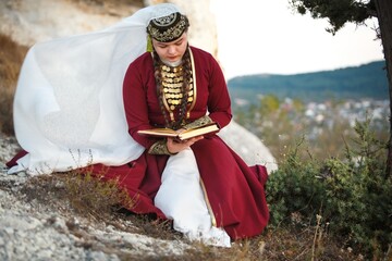 Sticker - Muslim woman in old retro tradition dress praying on mount