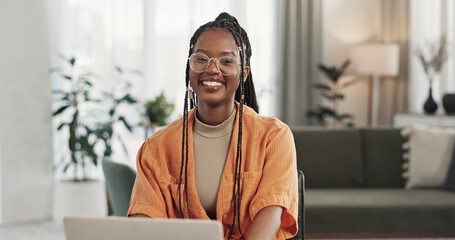 Poster - Black woman, portrait in home office and laptop for remote work, social media or blog research with smile in apartment. Happy freelancer at desk with computer for email, website or online in house.