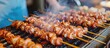 Octopus skewer is a popular street food at fresh markets in Japan, cooked on a traditional Japanese BBQ grill.