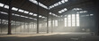 An old and empty hazy industrial ware house. Light coming in from the roof windows.