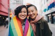 © blvdone - Same sex LGBT LGBTQ couple smiling on city street