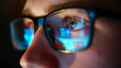 a close-up view of an eye seen through a pair of glasses reflecting blue digital data and graphs, suggesting a theme of technology and analytics