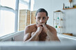 anxious depressed man with beard sitting in bathtub during breakdown, mental health awareness