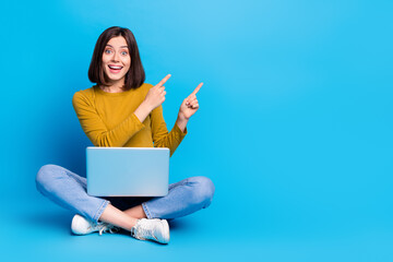 Poster - Full length photo of funky excited lady dressed shirt typing modern gadget pointing two fingers empty space isolated blue color background