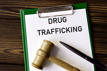 DRUG TRAFFICKING - words on a white sheet with a judge's gavel