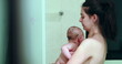 © Marco - Candid mother bathing newborn baby infant in shower