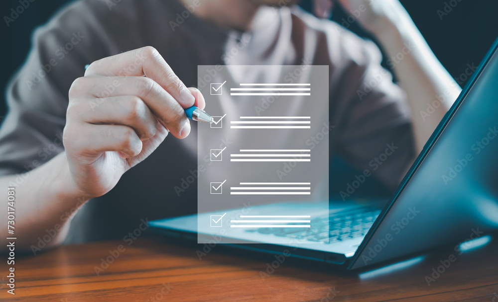 Businessman using laptop doing online checklist survey, Business ...