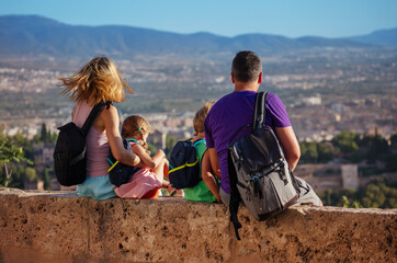 Wall Mural - Family with small kids take a break to enjoy Granada skyline