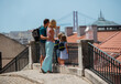 © Sergey Novikov - Happy young family on vacations look at famous Lisbon bridge