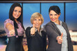 Three Women Showing Thumbs Up in the Office