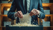 © lensofcolors - Close up of male hands destroying documents in a shredding machine with a pile of paper shavings.