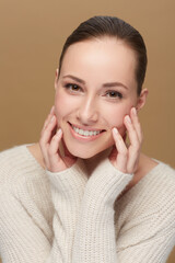 Poster - Hands, touching face and woman, beauty in studio with dermatology and wellness on brown background. Skincare, portrait and natural cosmetics, model with healthy skin glow and clean facial for shine