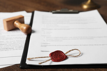 Canvas Print - Documents and stamp on wooden table, closeup. Notary contract