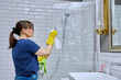 © Valerii Honcharuk - Woman cleaning bathroom, washing glass in shower