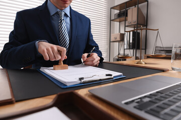 Sticker - Notary with pen stamping document at table in office, closeup