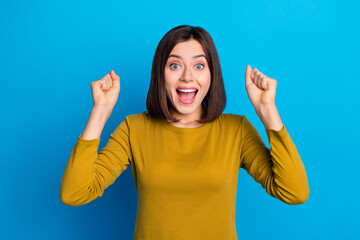 Poster - Photo of adorable lucky woman wear shirt rising fists screaming yeah isolated blue color background