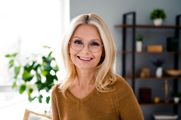 Poster - Photo of cheerful lovely pretty senior lady agent banker standing in light room indoors workplace